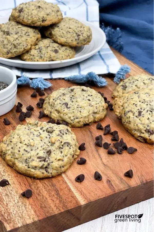 A plate of freshly baked oatmeal cookies placed on a wood countertop.