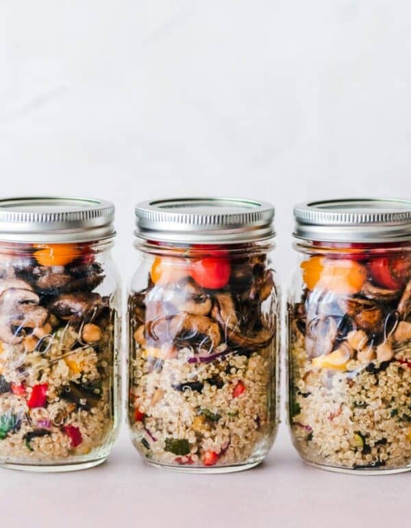 Colorful quinoa salad jar with roasted veggies, ideal for healthy meal prep.