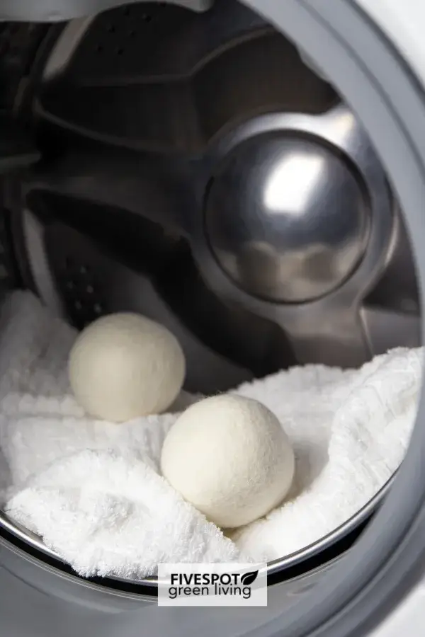 Wool dryer balls placed on a soft towel, depicting an eco-friendly and reusable alternative for reducing static and softening laundry naturally.