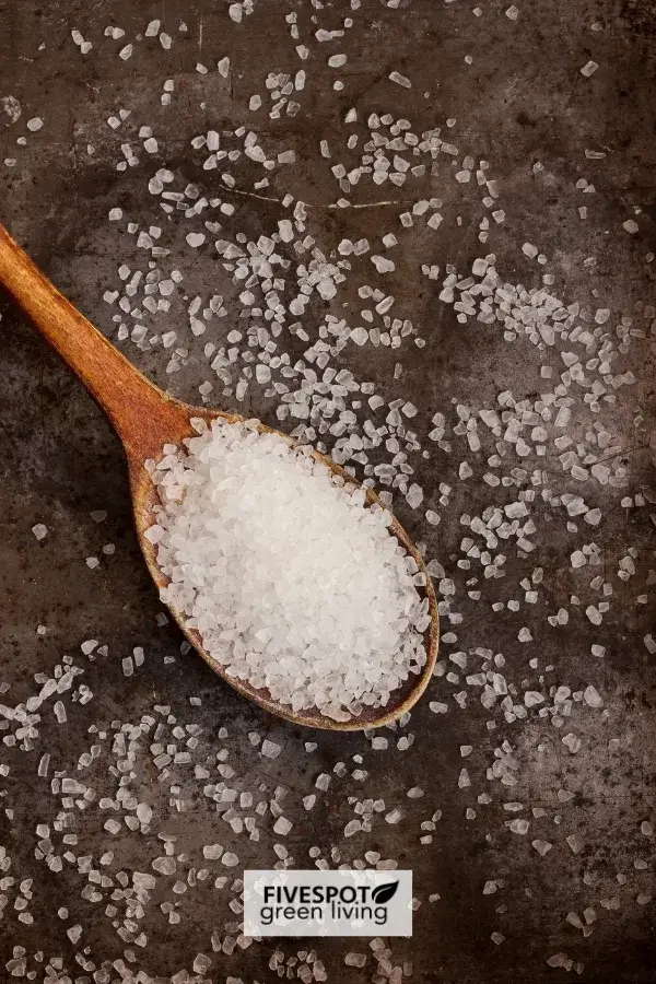 A wooden spoon filled with Epsom salt, symbolizing a natural remedy often used for relaxation, soothing sore muscles, and promoting wellness.