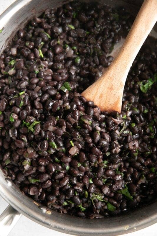 black beans with wooden spoon
