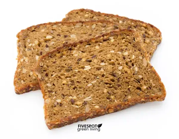 A loaf of Ezekiel bread sliced with hearty texture.