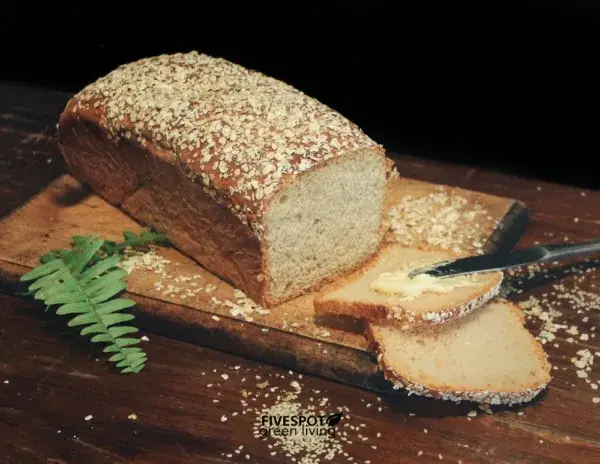 Slices of oat bread on a wooden board, topped with whole oats.