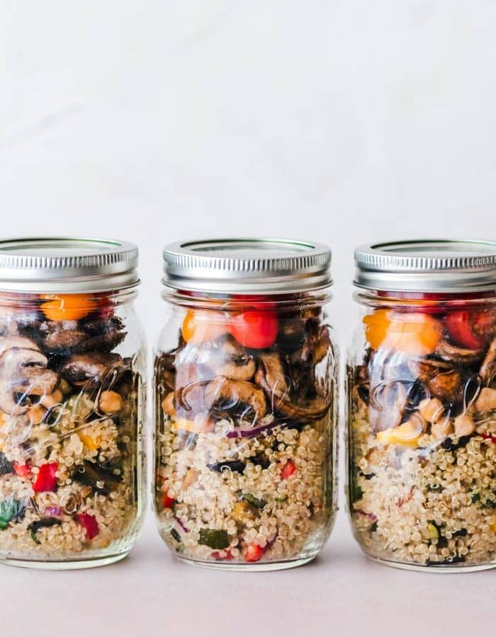Colorful quinoa salad jar with roasted veggies, ideal for healthy meal prep.